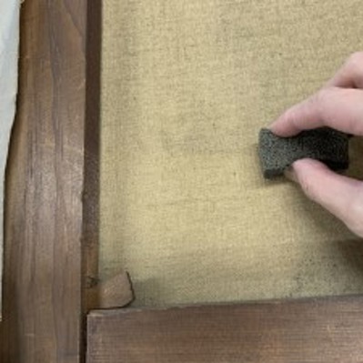 Cleaning the canvas with a smoke sponge